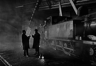 Shed officials in discussion beside a line of loco's by the turntable in the gloom of Barrow Hill MPD on 1st March 2017 (Iand49 (Instagram @iand.49))
